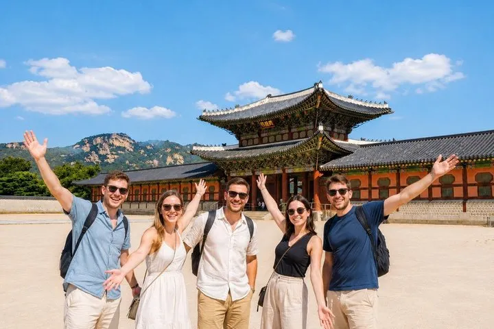 Visitors in rented hanbok walking the Gyeongbokgung courtyard on a customizable day with seoul private tours
